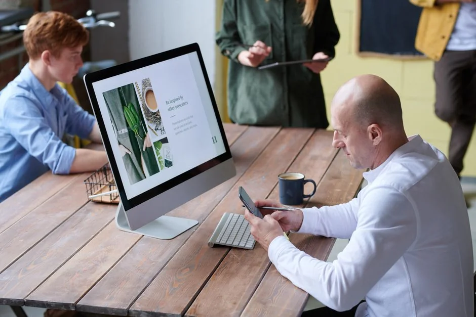 A contemporary computer display showing web design work and highlighting creative visuals in a workspace.
